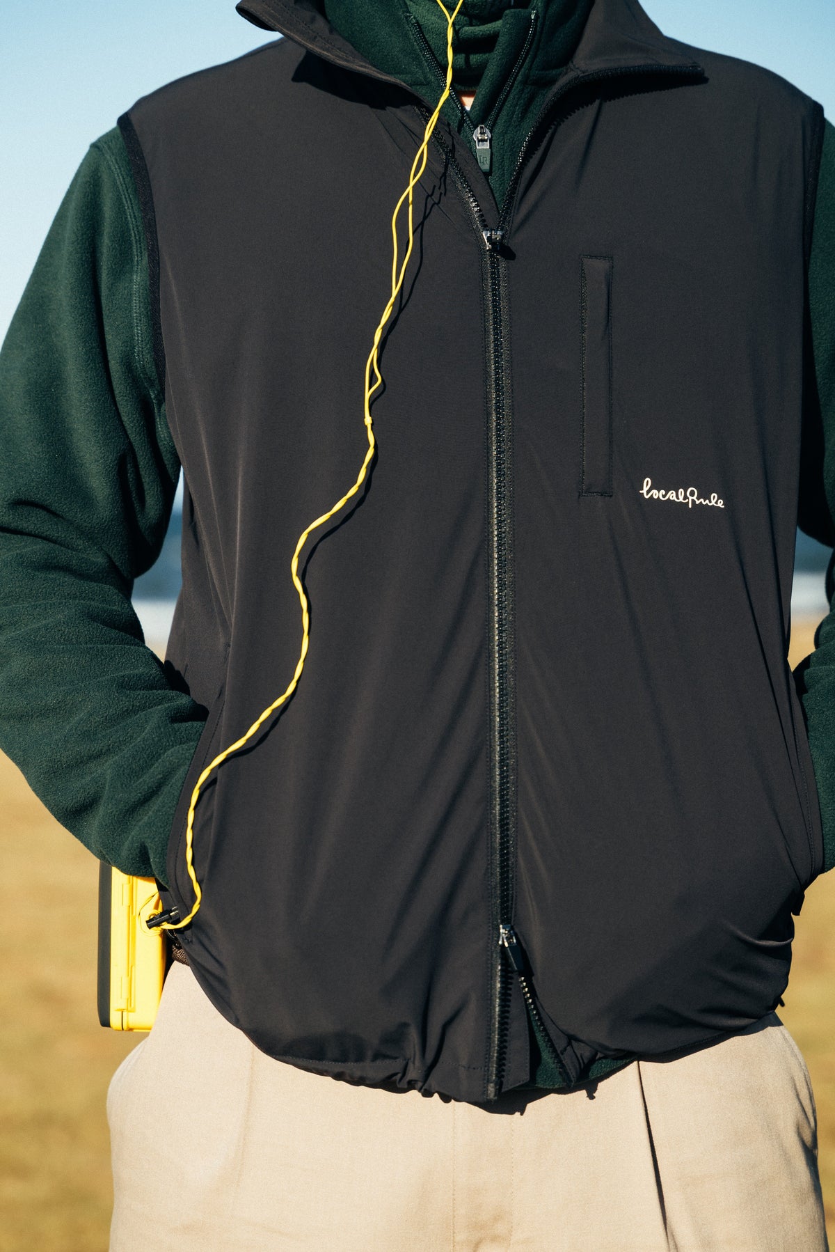 Premium Scandinavian golf apparel, rangefinder, GPS watch, and essentials arranged as the best gifts for golfers on the green
