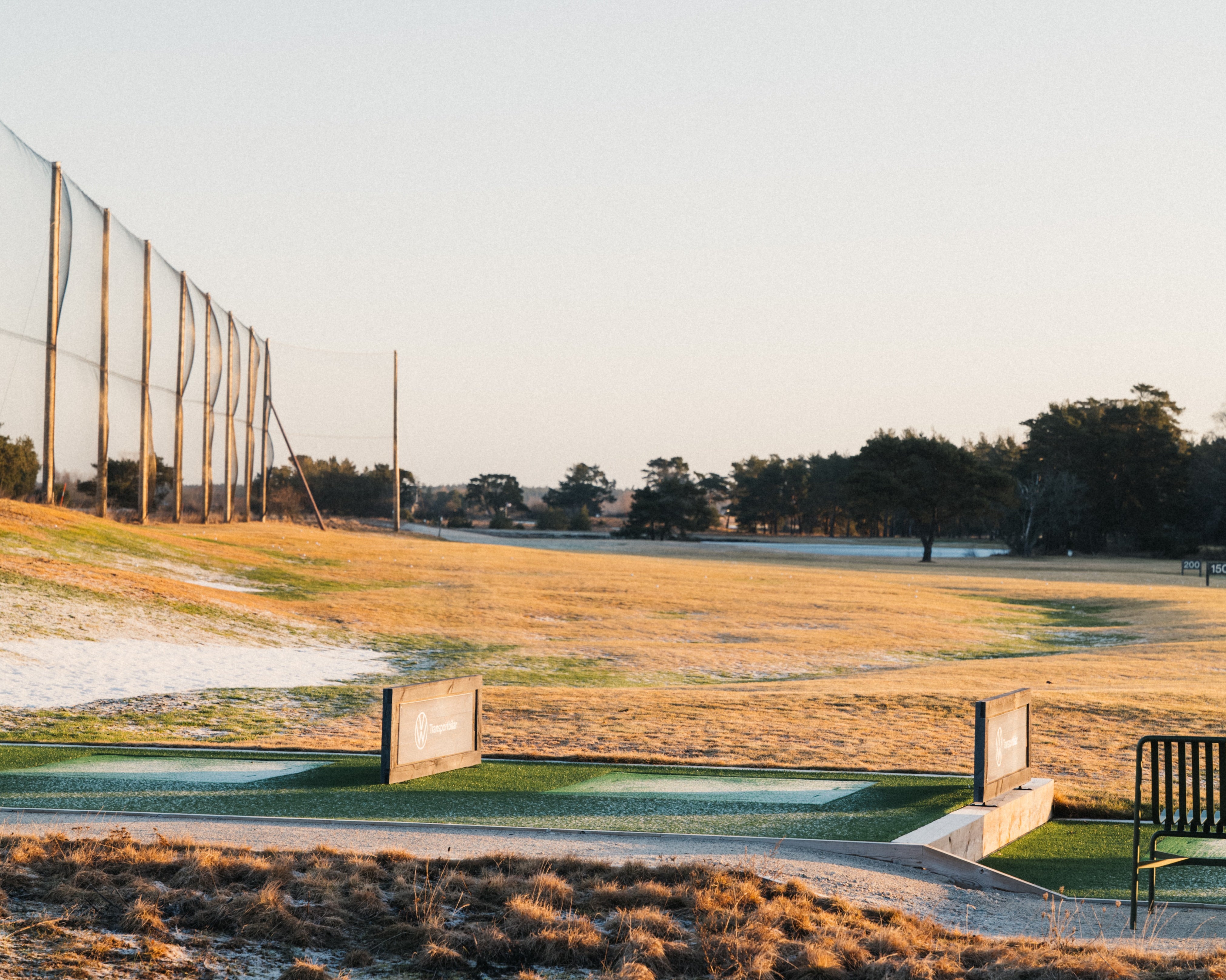 Golfers comparing scorecards on a scenic course, discussing what is a good golf handicap and enjoying premium apparel