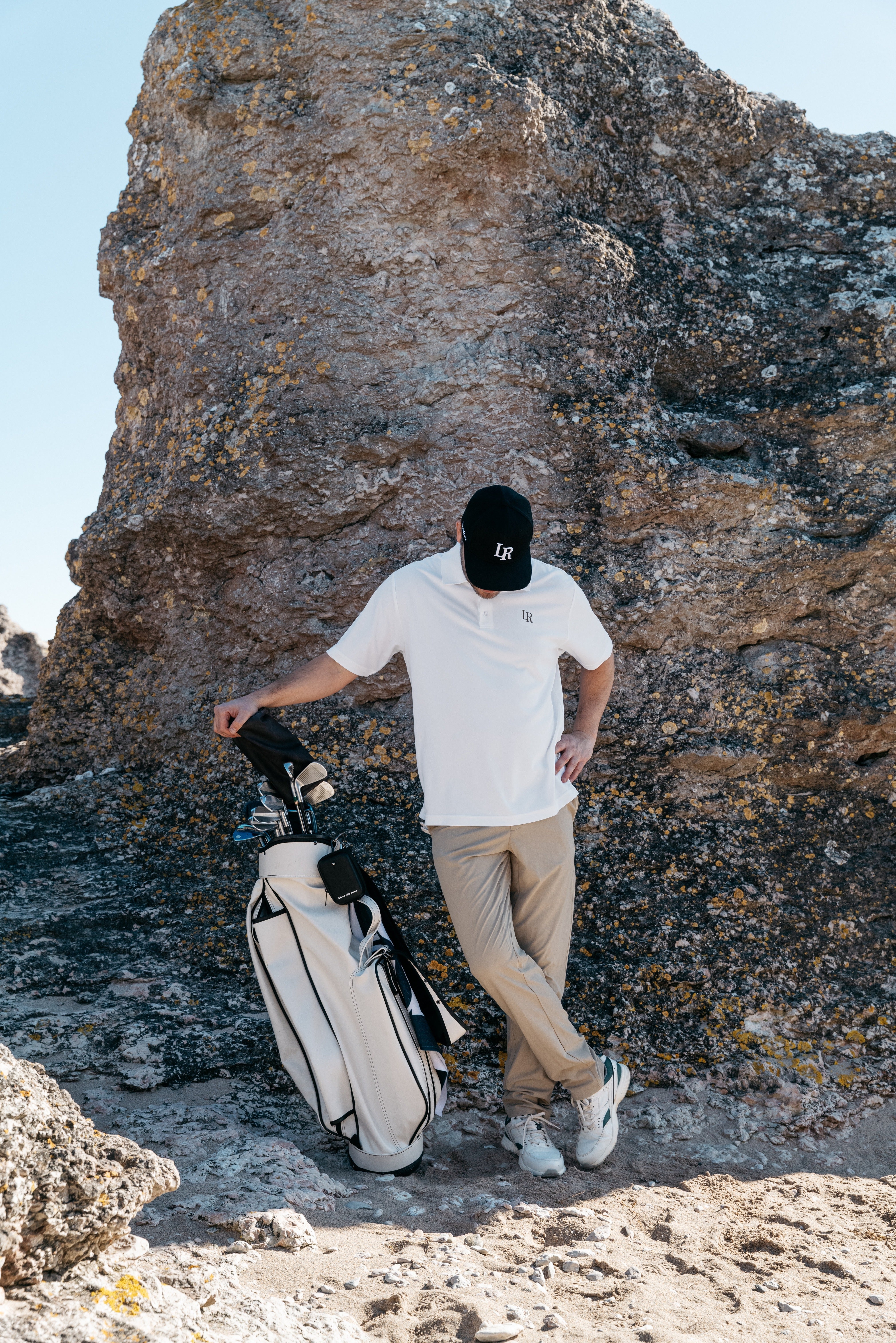 Golfer searching the rough for a lost ball with a clock emphasizing how long can you search for a golf ball on the course
