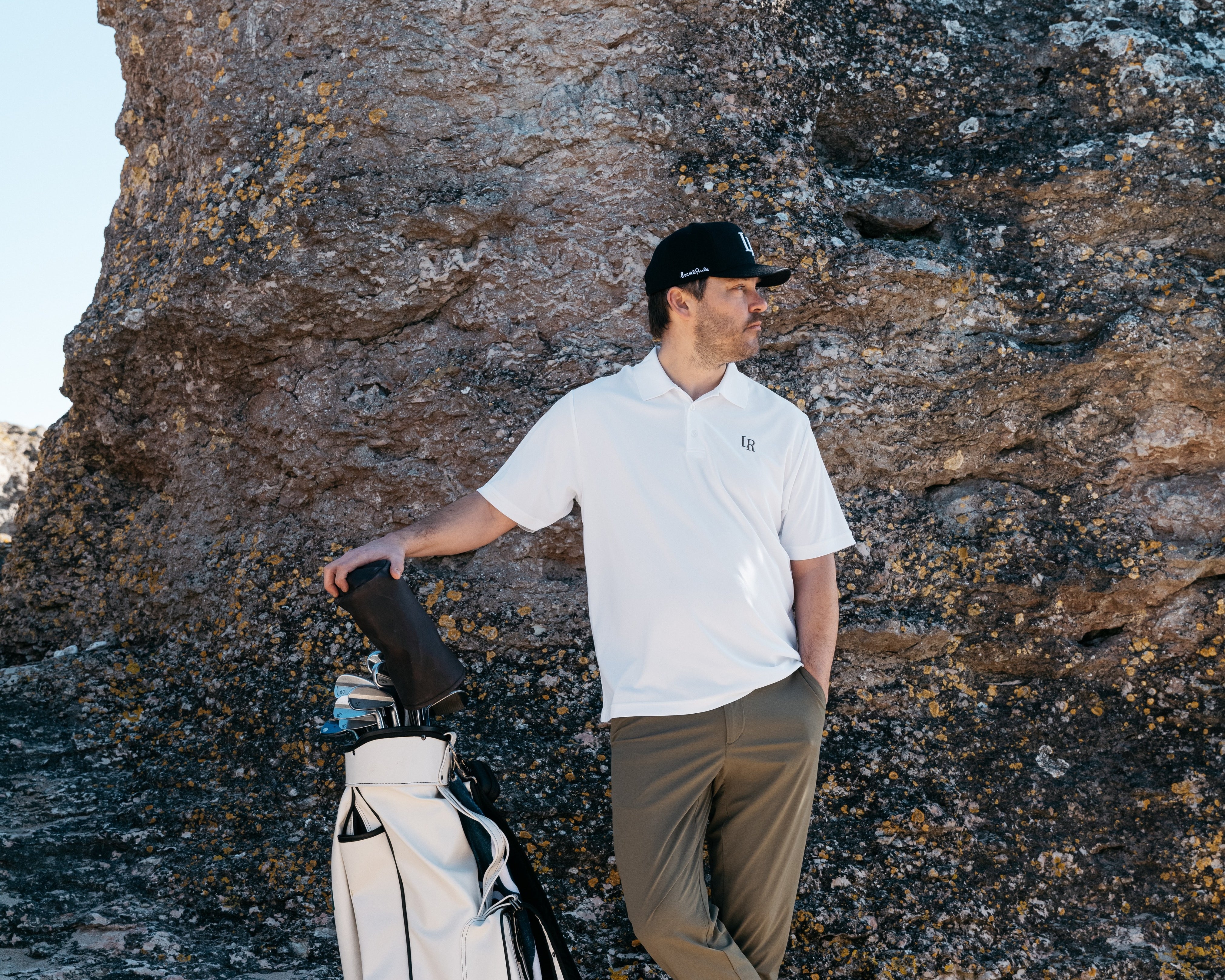 Male and female golfers in premium collared polos, tailored shorts, and proper shoes, illustrating a golf dress code guide
