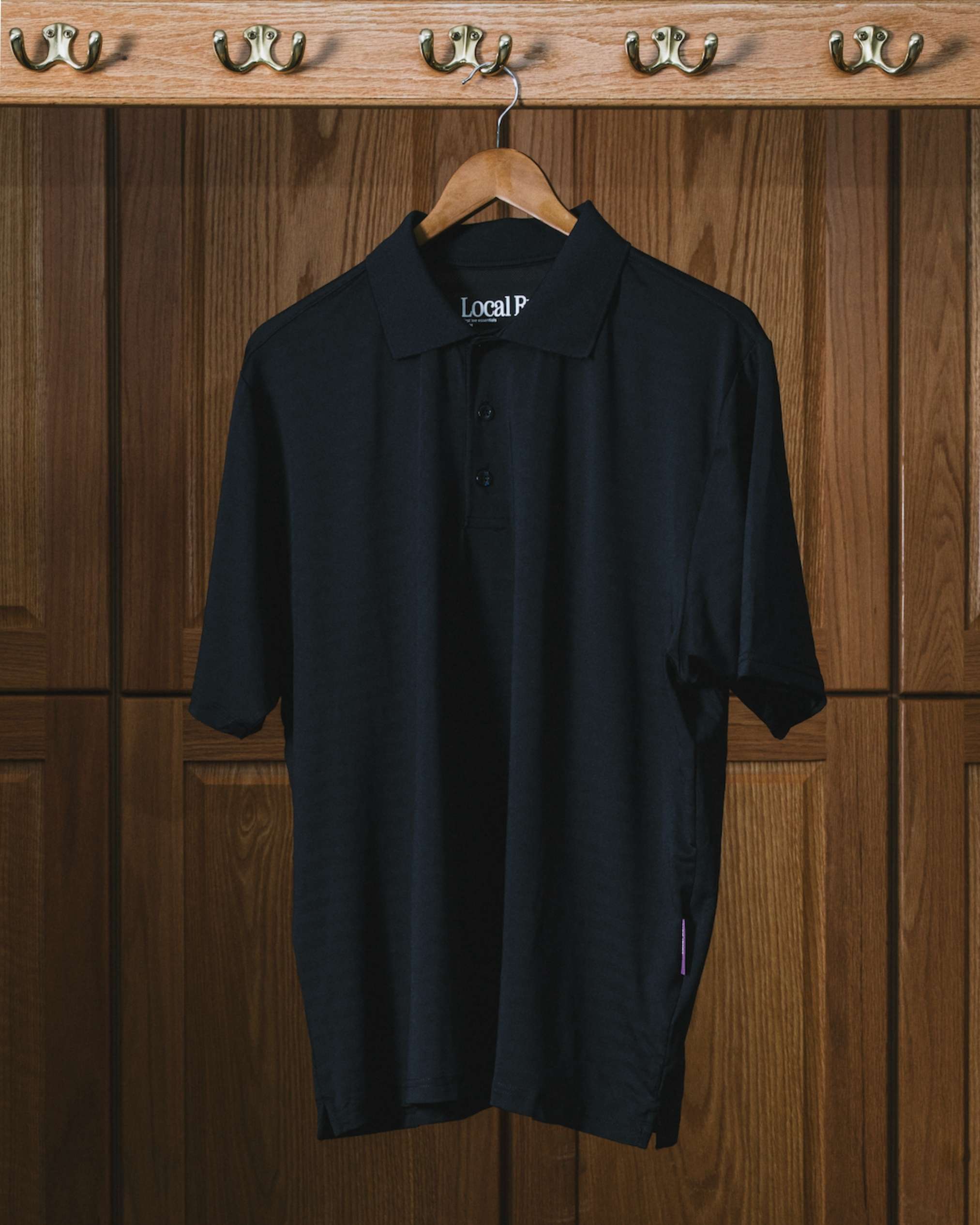 LocalRule_TechPolo_Navy_Closeup_Lockerroom.jpg